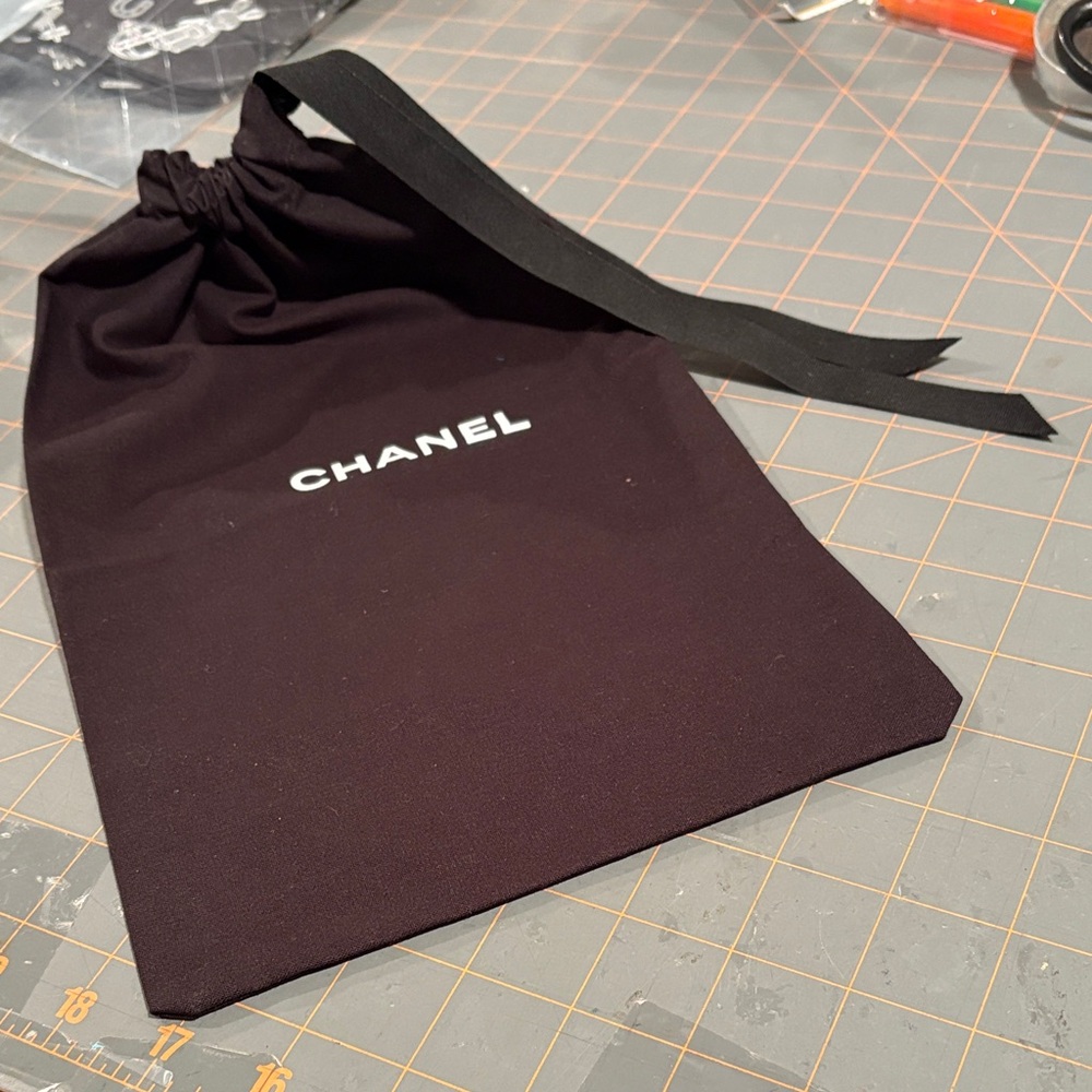 NWOT Authentic CHANEL Black Drawstring Pouch with White Logo